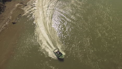 speedboats chasing each other on a shallow winding river with friends