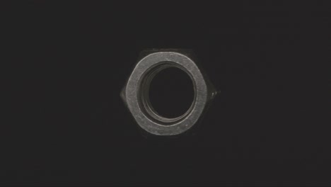 metal nut spinning in the void on a black background