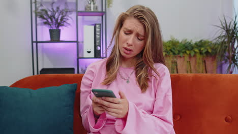 Portrait of adult girl use smartphone surprised by bad news, fortune loss, fail, lottery results