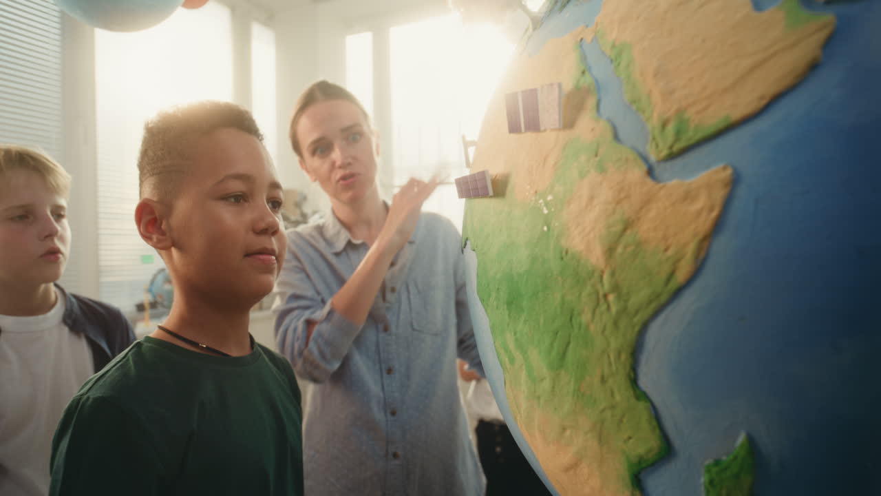 Science STEM Lesson School Boy Attaching Miniature Solar Panel to Earth Model