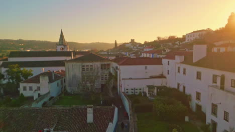 old town sunset drone view. city with church steeple at golden light.