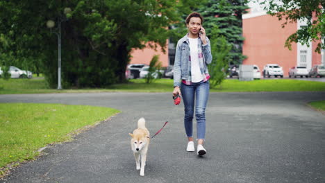 woman walking dog in park