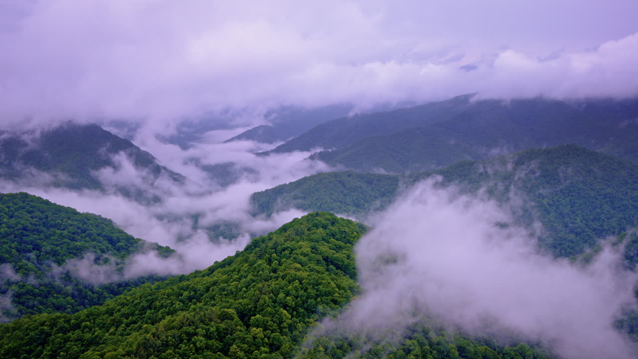 Drone shot gliding over fog-covered Appalachian terrain
