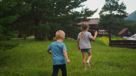 Boy-and-girl-walk-along-meadow-spending-time-at-countryside