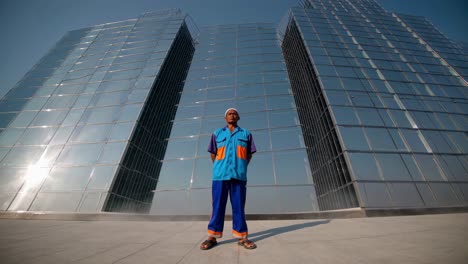 worker in front of modern skyscrapers