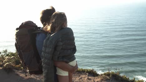 dad with camping backpack holding an hugging daughter kid