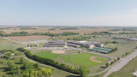 aerial view of american rural high school nestled in expansive countryside landscape