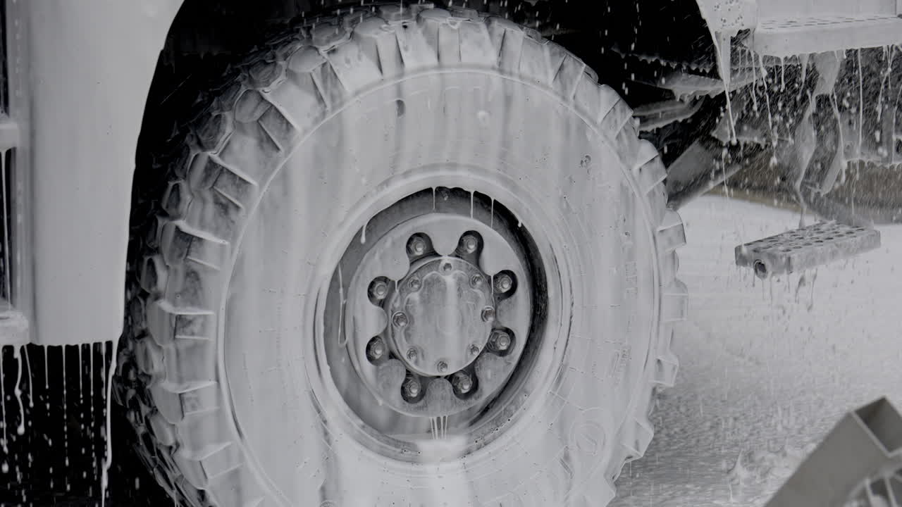 Large Truck Tire Being Washed with Soap Foam
