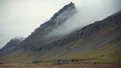 Fog-slowly-rolls-down-a-mountain-in-Iceland-countryside