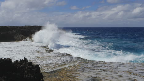 huge waves crashing against rocky cliffs, isle of pines, new caledonia, slow motion