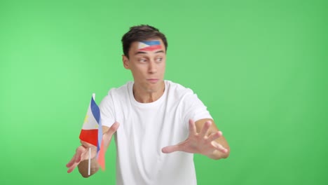 man cheering for philippines screaming and waving a national flag