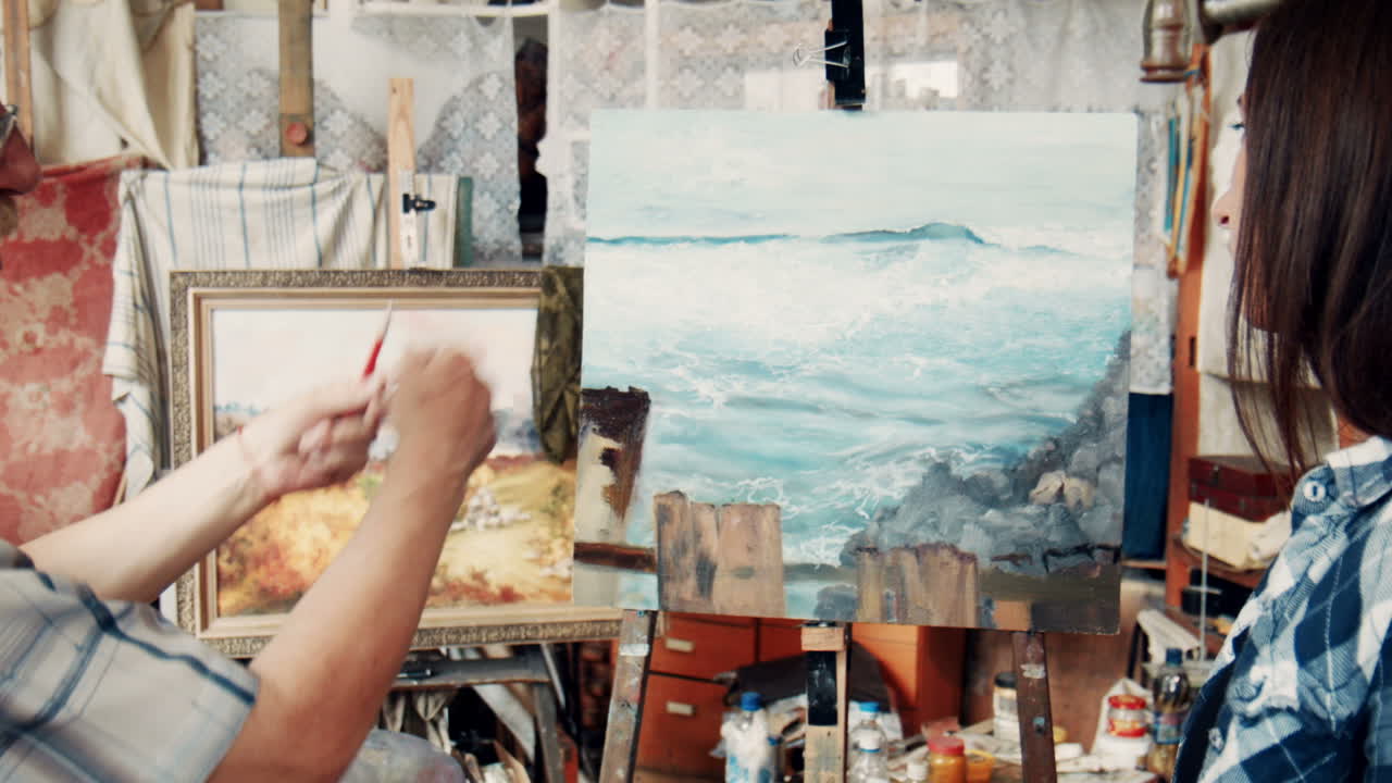 Art Student Discusses Painting with Mentor