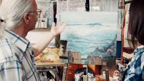 art student discusses painting with mentor