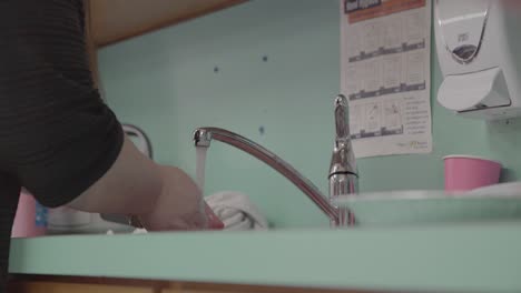 child and adult washing hands in a daycare