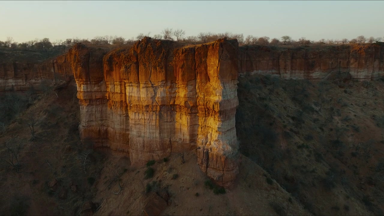 Drone closeup of Chilojo Cliffs lit by sunrise in Gonarezhou National Park, Zimbabwe