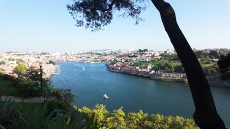 People enjoy a peaceful summer day overlooking the river from a shaded garden viewpoint