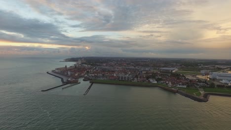 Aerial:-The-boulevard,-beach-and-city-of-Vlissingen-during-sunset