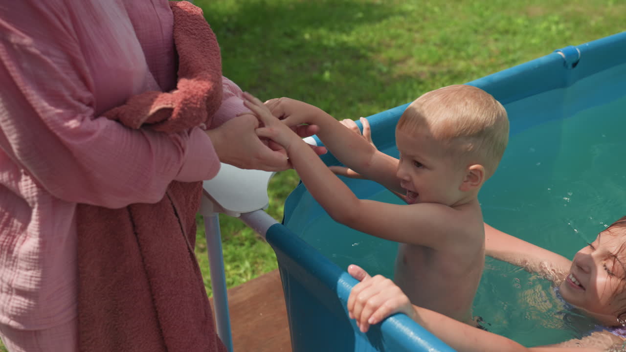 Youngster Struggles As Mother Stabilizes, Kid Earnestly Seeks Assistance As Mother Keeps Grounded, Young Child Desperately Attempts To Hold On While Mother Offers Steadiness And Support