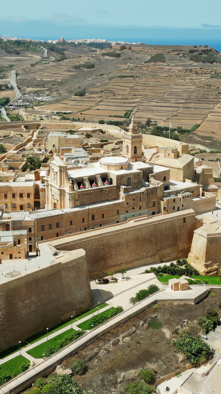 Aerial drone view of the Gozo island in Malta, in the Mediterranean Sea. Vertical vertical