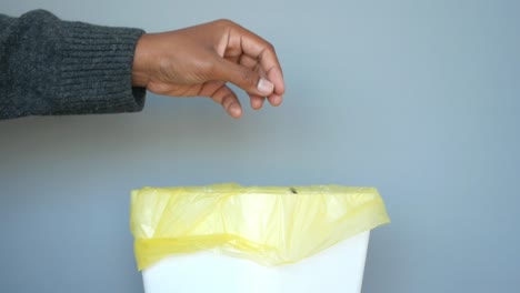 throwing away a banana peel in a trash can