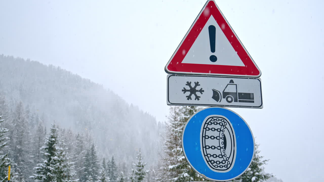 Sign warning drivers about hazardous winter road conditions, enforcing the use of tire chains to ensure safe travel while snowing in the Dolomites, Italy