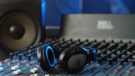 headphones on a mixing desk in an audio recording studio