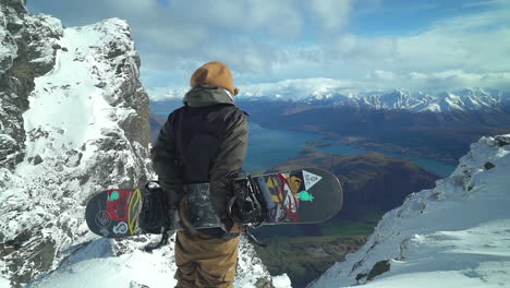 male snowboarder enjoying the great view from the glacier on a windy day