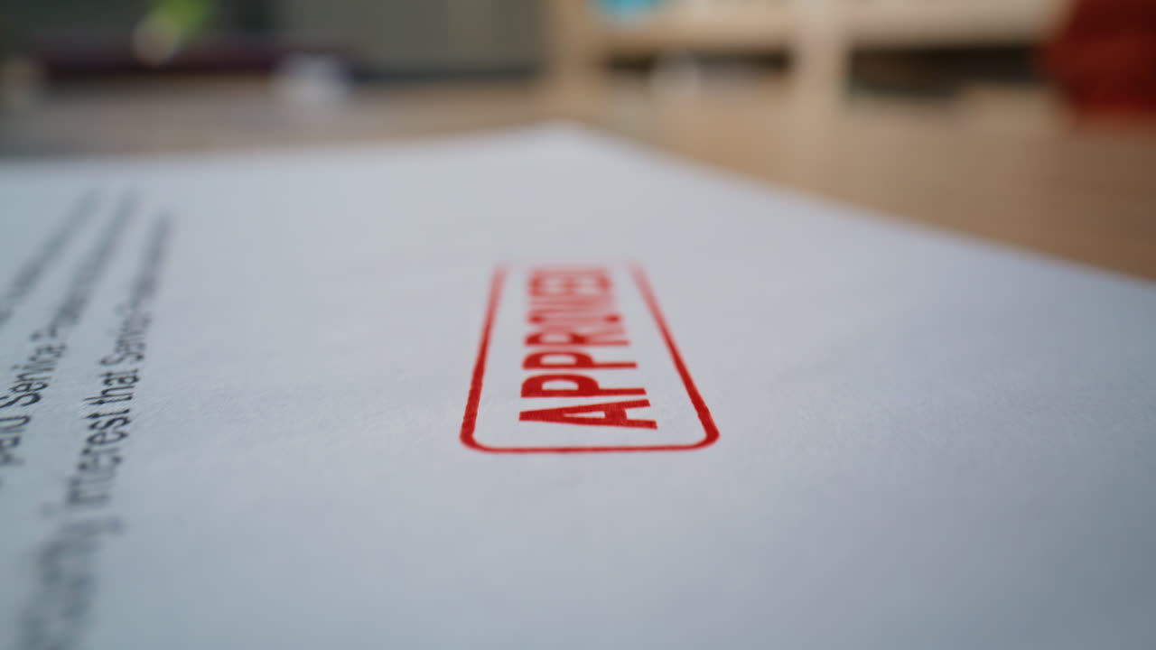 Macro stamped business contract placed on wooden desk. Legal office document