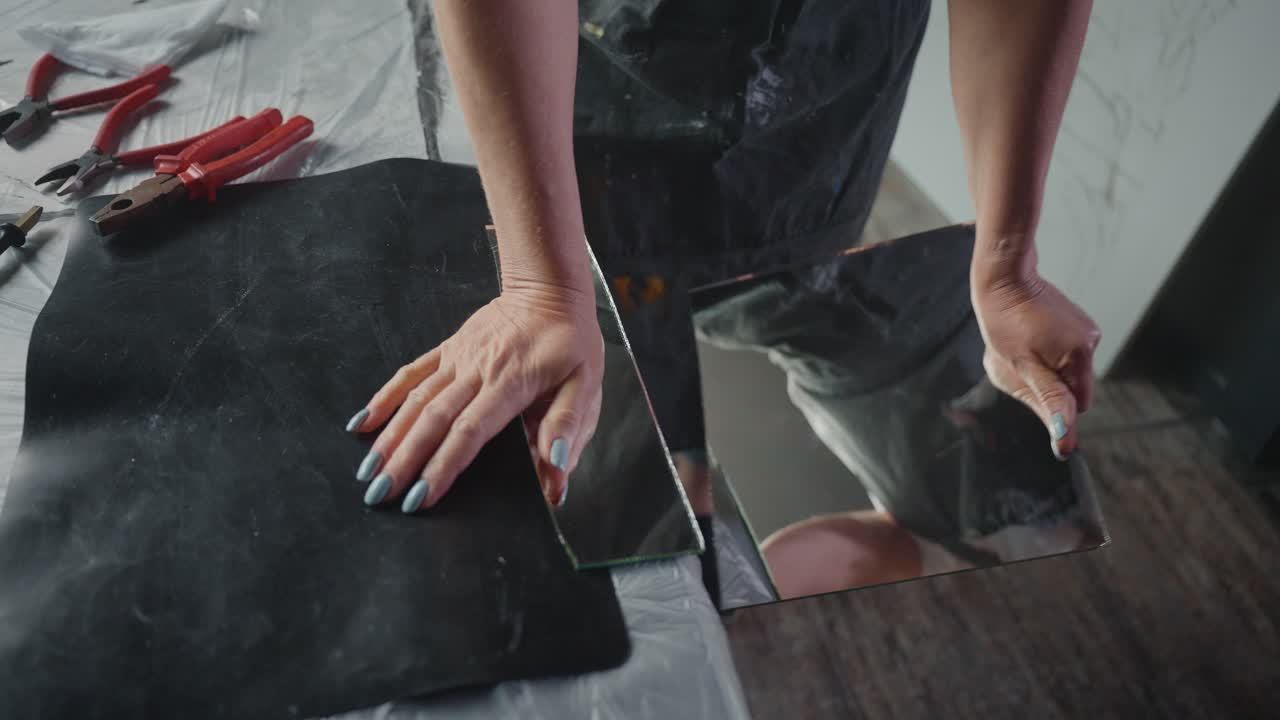 Woman Repairing or Installing a Mirror