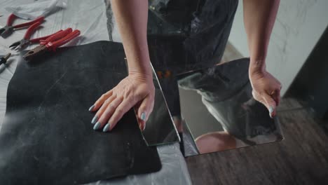 woman repairing or installing a mirror