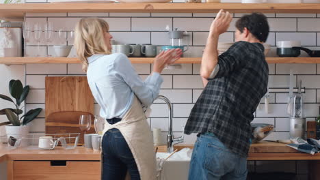 love, cleaning and kitchen couple play with dish