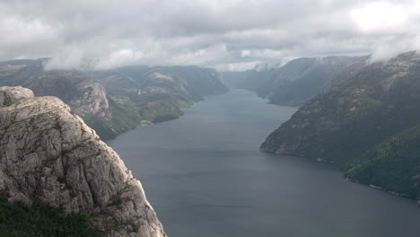 Impressive-Timelapse-of-the-Lysefjorden-View-from-the-Pulpit-Rock,-Preikestolen-in-Norway,-Cloudy-Foggy-Day,-Mass-Tourism-in-Bad-Weather