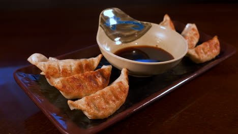 appetizer of japanese gyoza with dipping sauce, potsticker pan fried dumplings, slider 4k