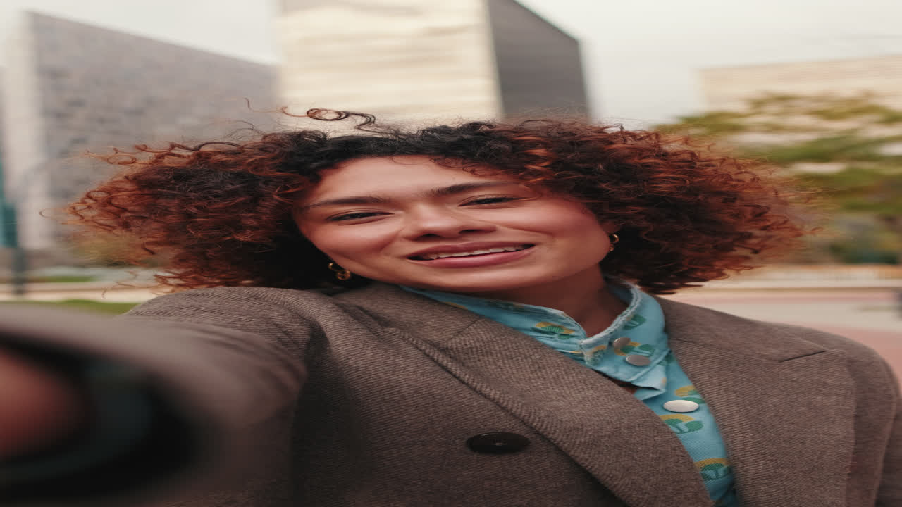 Happy Young Woman Waving at the Camera in the City