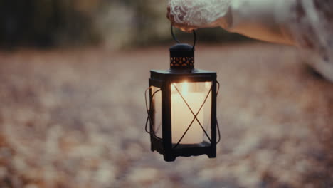warm candlelight lantern in a blurry outdoor setting