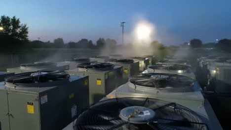 outdoor cooling units at night with fogging