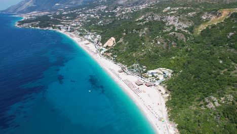 Idyllic-Dhermi-Beach-in-Albania:-Azure-Sea,-Green-Hills,-Beautiful-Resorts,-Hotels,-and-a-Summer-Getaway-Destination