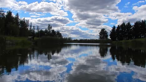 blue lake water rippling mirror reflection bright scenic cloudy sky