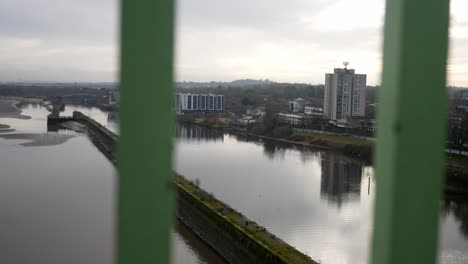 looking through wrought iron metal railing to suburban waterfront canal apartments dolly left