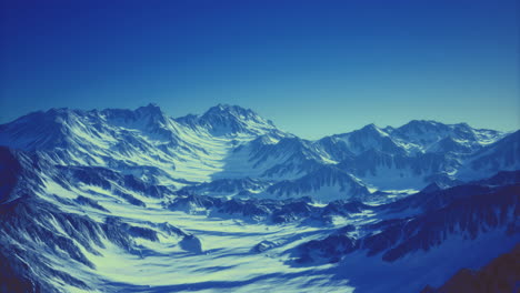majestic snow covered mountain range under clear blue sky at twilight