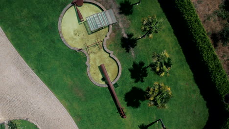 aerial top view of violin-shaped lake in lush mansion