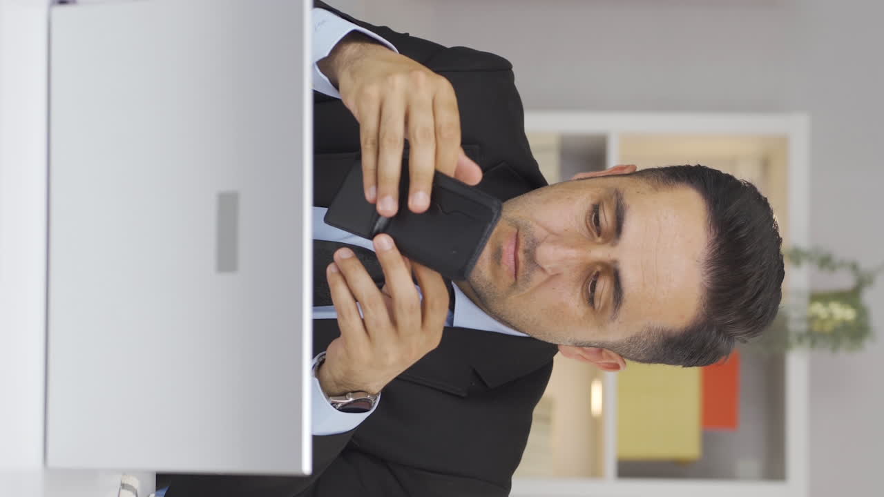 Vertical video of Home office worker man showing his empty wallet to the camera.