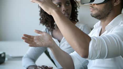 Two programmers setting VR headset