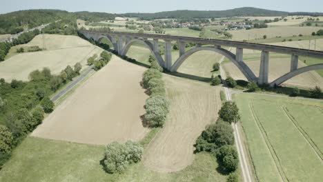 Beautiful-train-viaduct-crossing-the-German-Autobahn-A7-Motorway,-Germany,-Europe