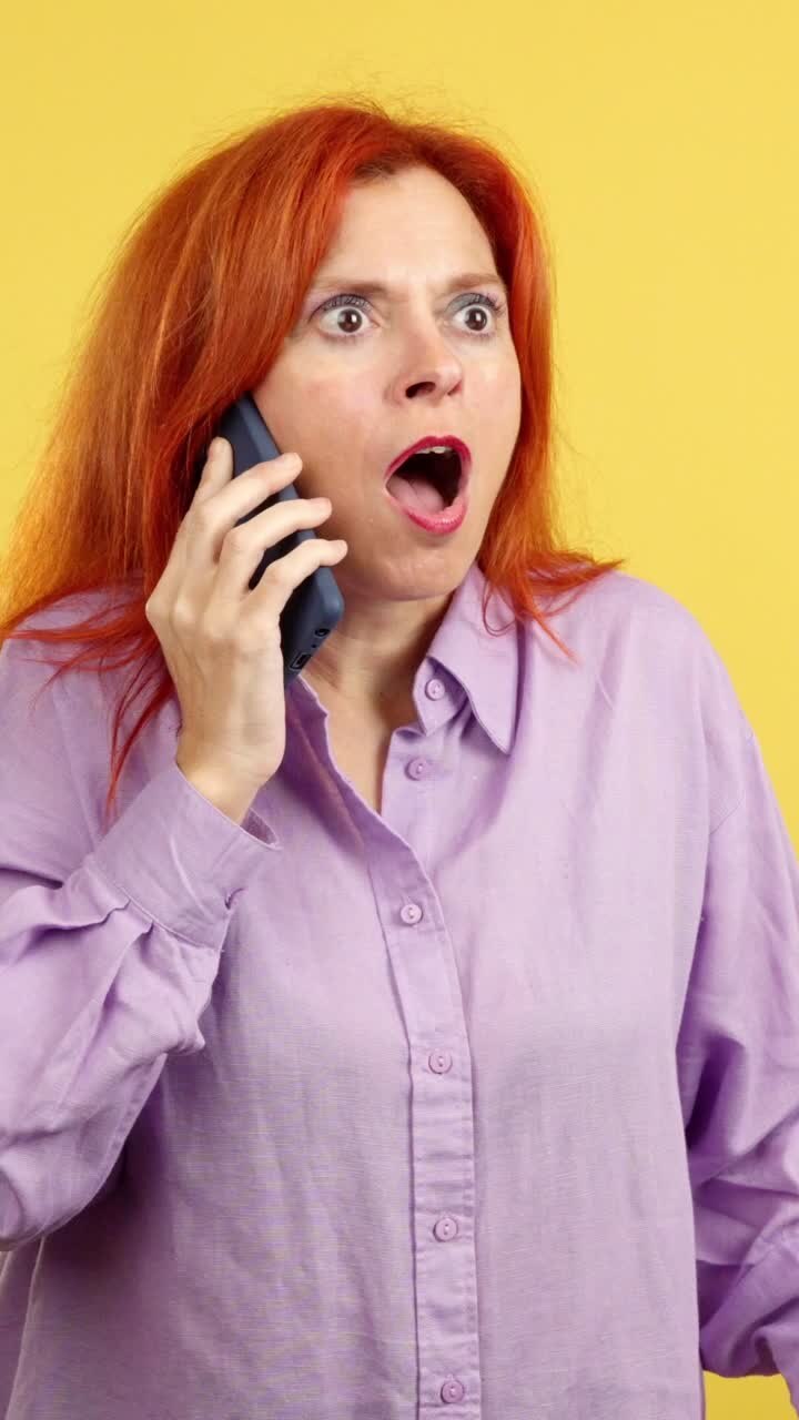 Shocked woman talking on a mobile phone