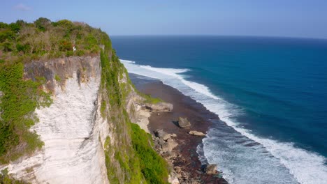 aerial shot of beautiful karang boma cliff in indonesia on a sunny day with blue skies