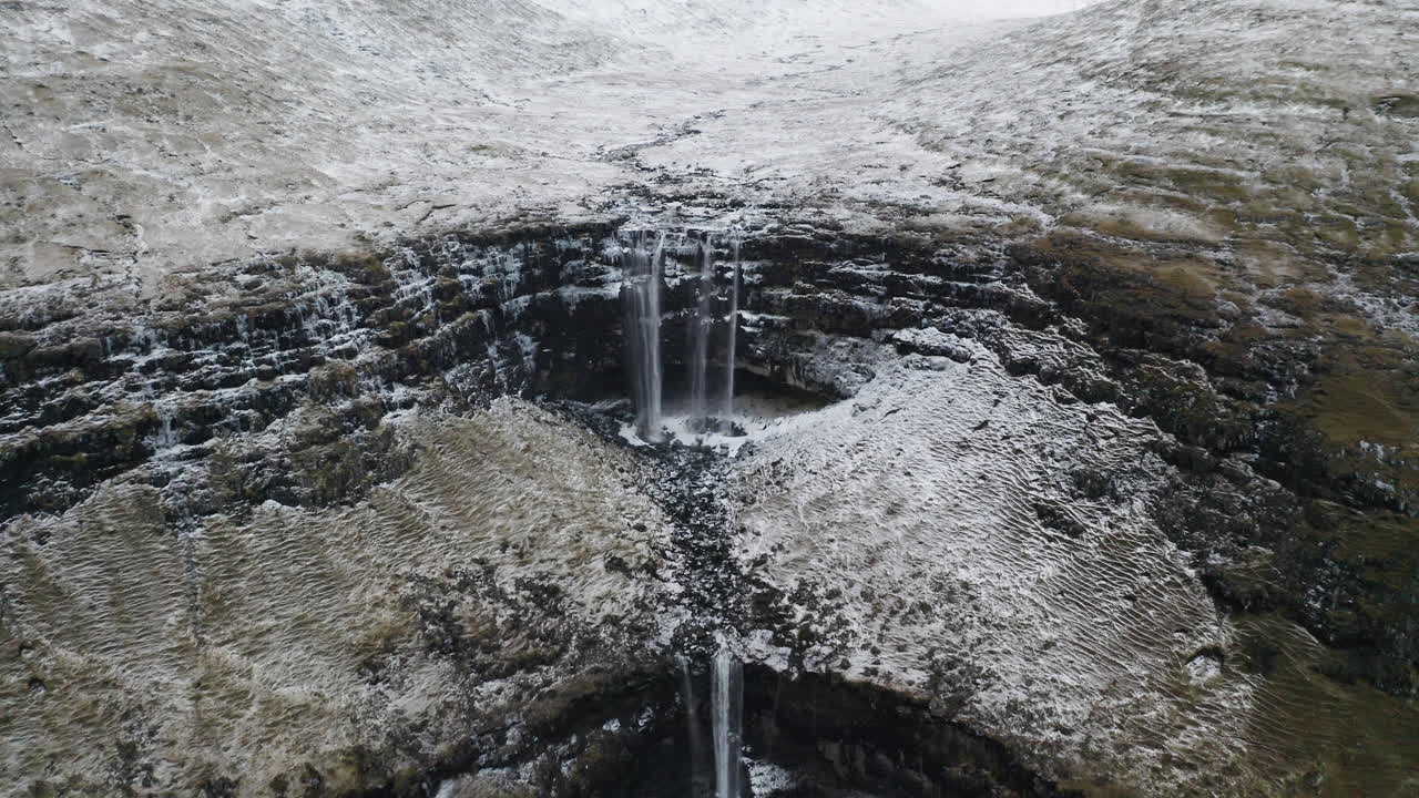 Faroe Islands, 4K Aerial mid shot push in of beautiful Foss&aacute; waterfall
