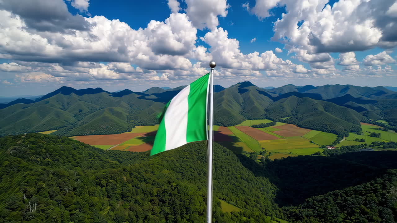 Nigerian Flag Flying Over Mountains