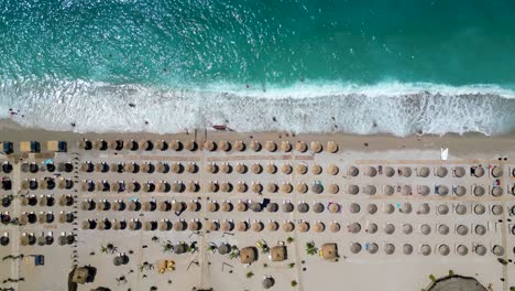 Beautiful-beach-with-sun-umbrellas-and-waves-crushing-down