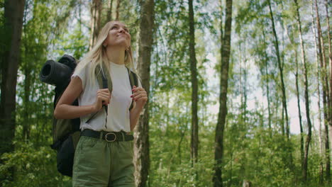 walking through the woods with a backpack to inspect the forest beauty